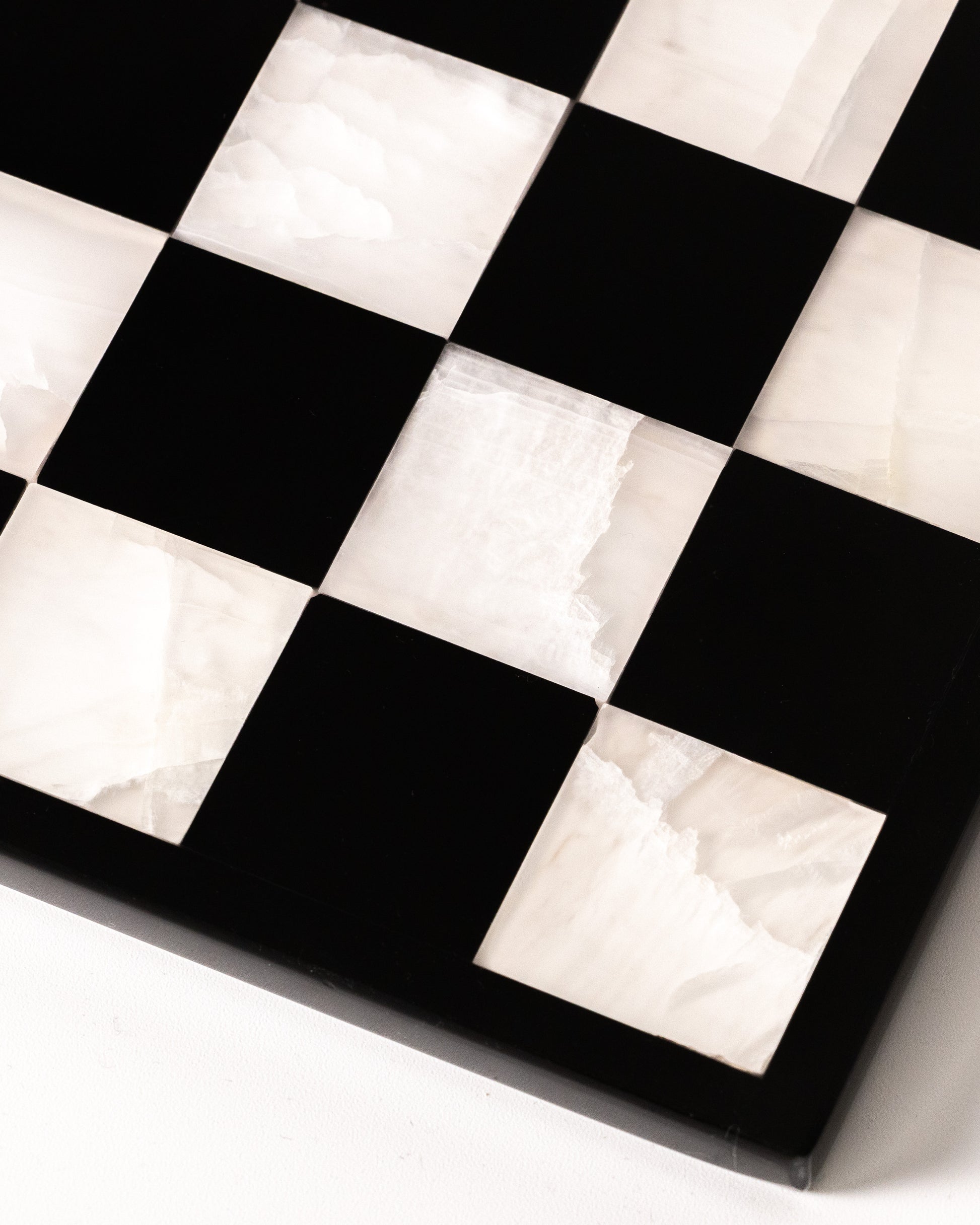 Marmonix luxury chess set handcrafted from white translucent onyx and polished black marble.