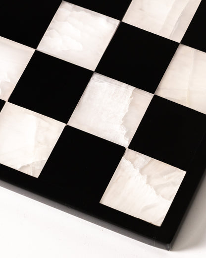 Marmonix luxury chess set handcrafted from white translucent onyx and polished black marble.