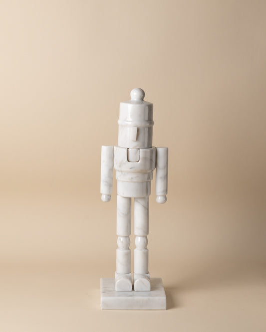 White marble nutcracker figure on a beige background