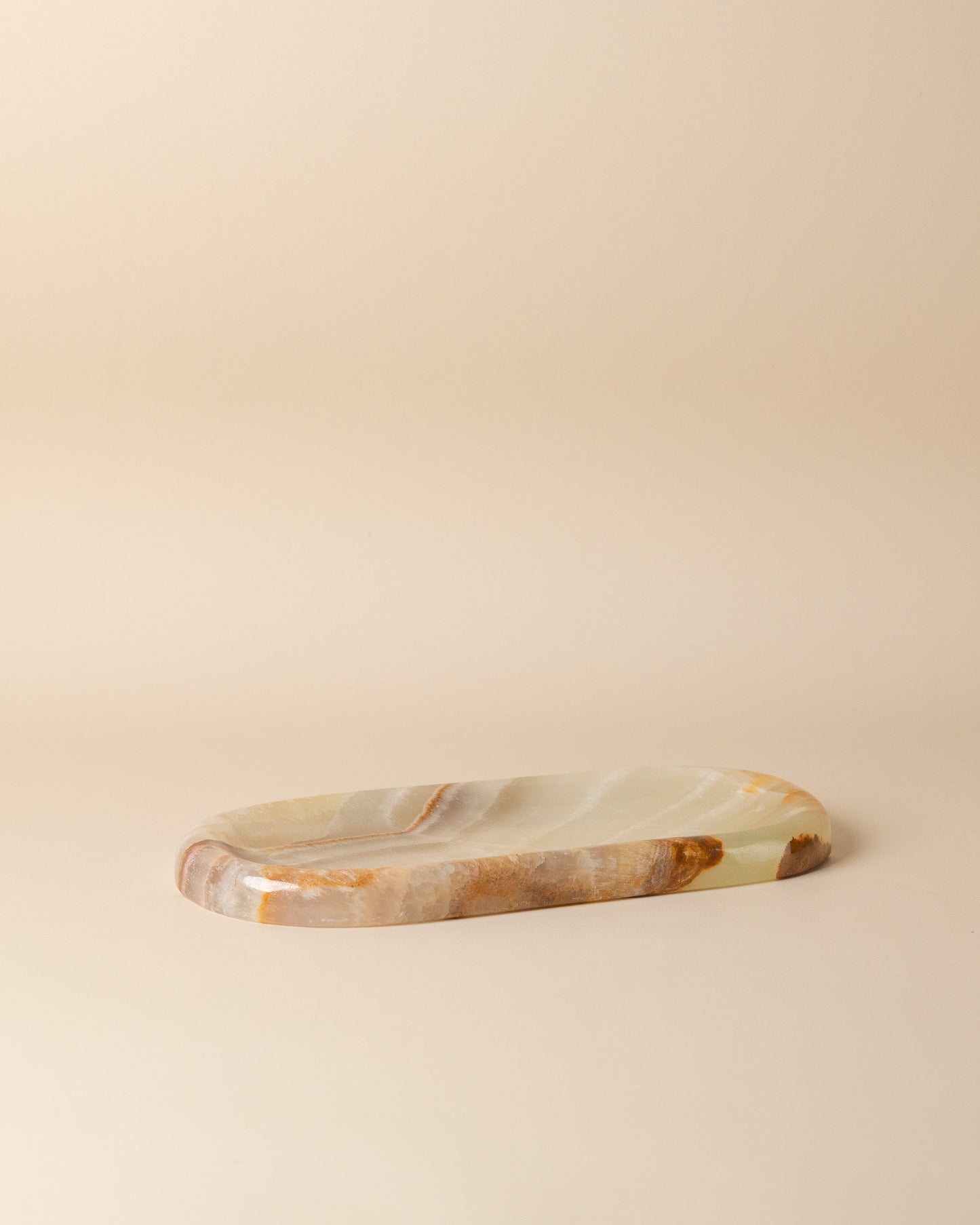 Marble-patterned stone tray on a beige background