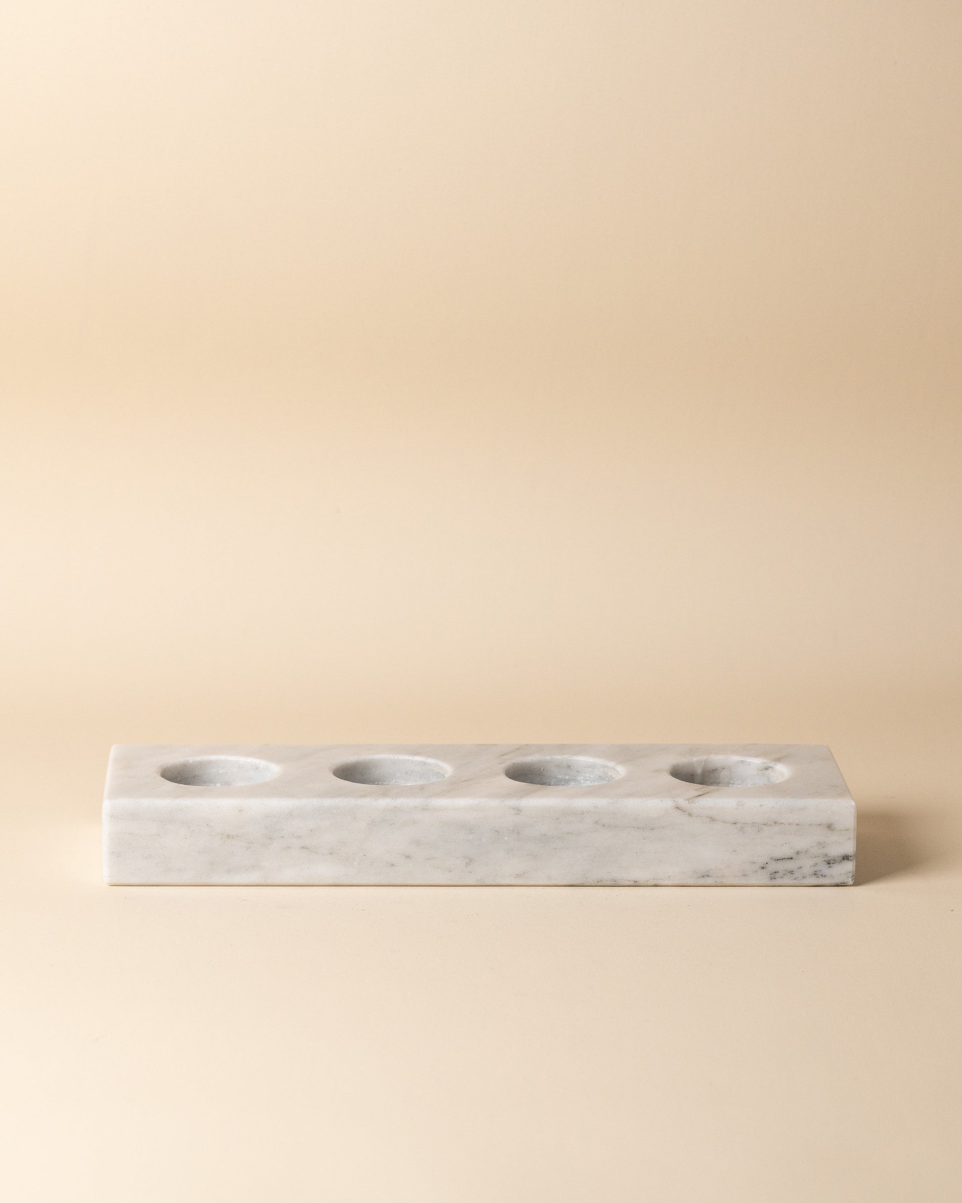 Marble rectangular candle holder on a beige background