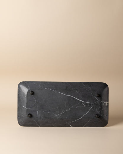 Black marble tray on a beige background